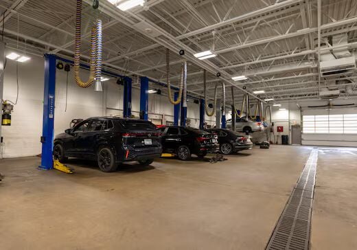 Several Volkswagen cars being worked on inside the Flow Volkswagen of Winston-Salem dealership servi…